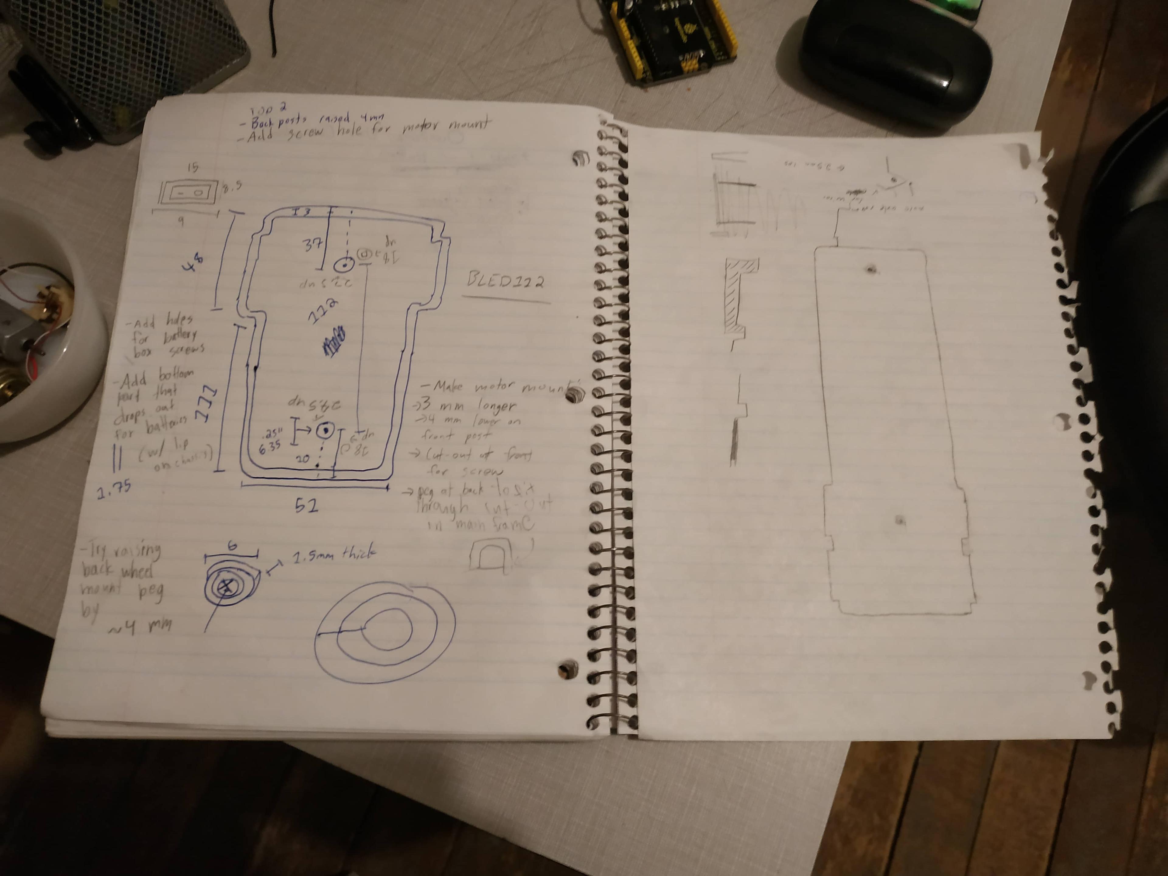 An open notebook full of scribbles and numbers. A sketch of the buggy is on the right, and its dimensions are on the left side