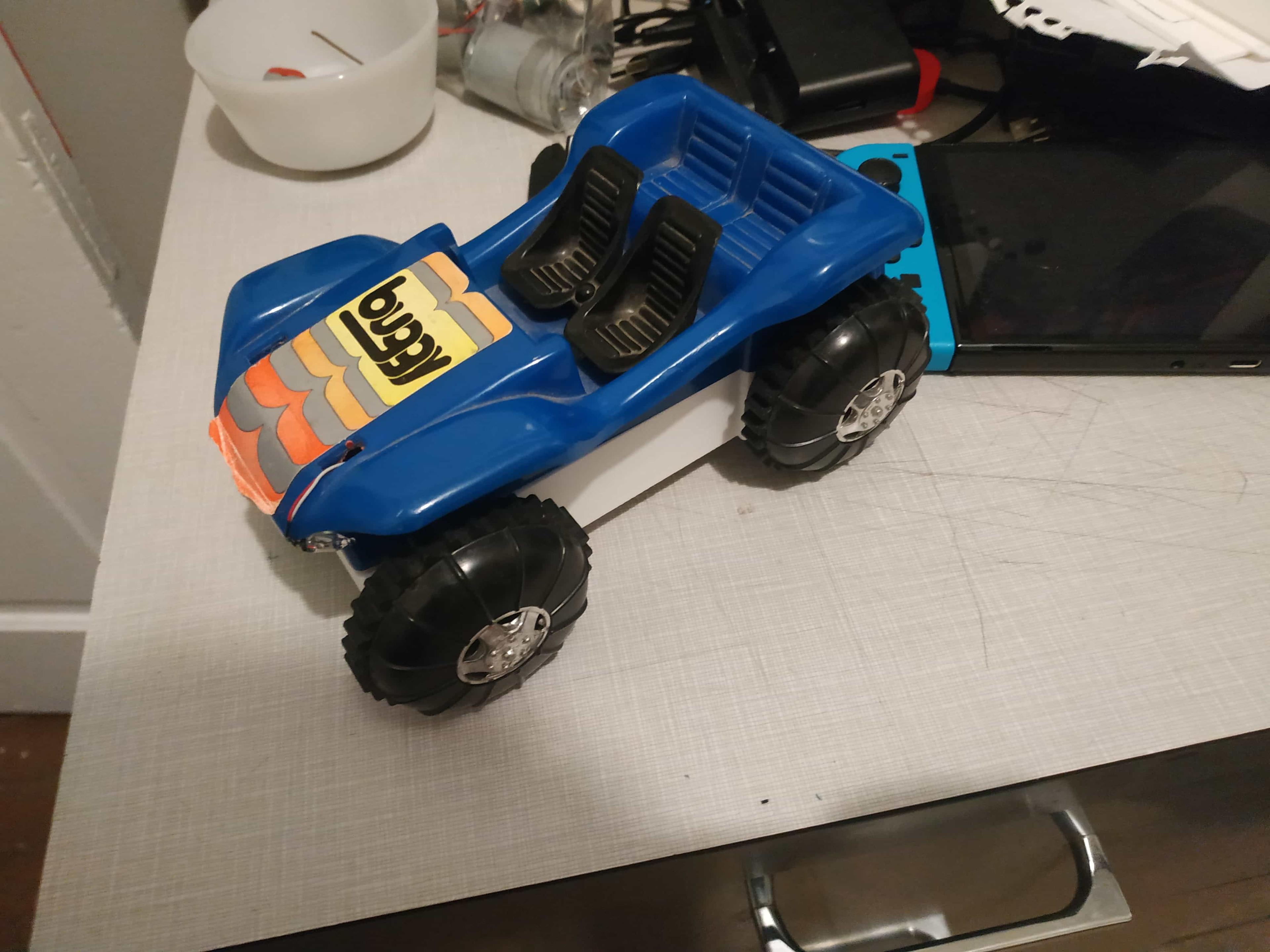 The top part of the buggy, as well as its drivetrain, have been successfully connected to my 3D printed base