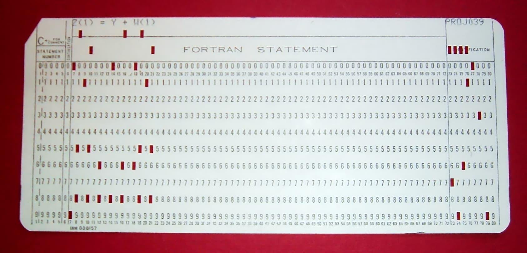 A rectangular paper card with rows of numbers and small rectangular holes, with the name FORTRAN STATEMENT at the top