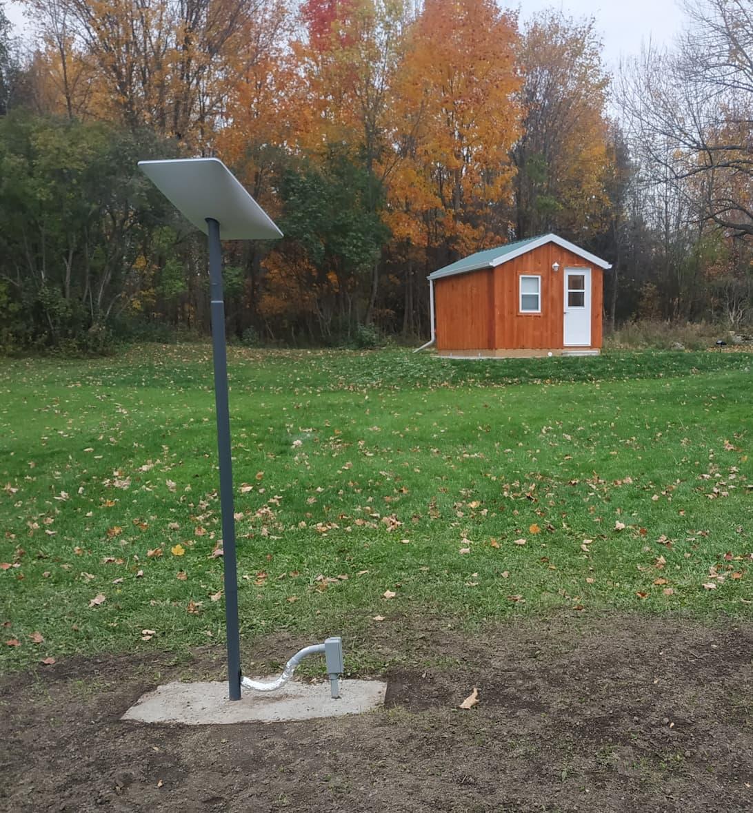 My dish sits atop its pole, facing roughly towards my office cabin in this shot, with colourful autumn trees in the background