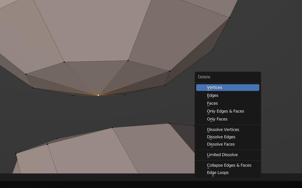 A point at the bottom of a sphere is selected, and the Delete Vertices context menu option is highlighted