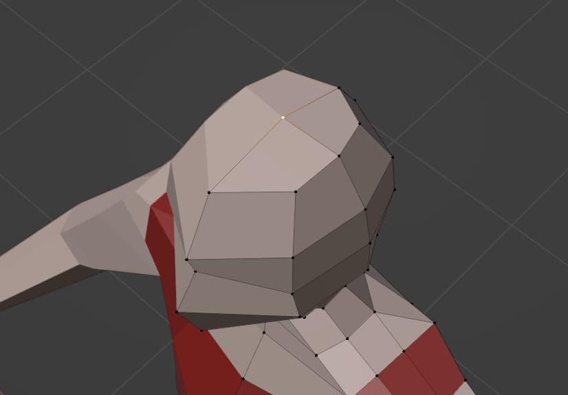After removing some faces and repositioning some vertices, the top of the head now appears flat