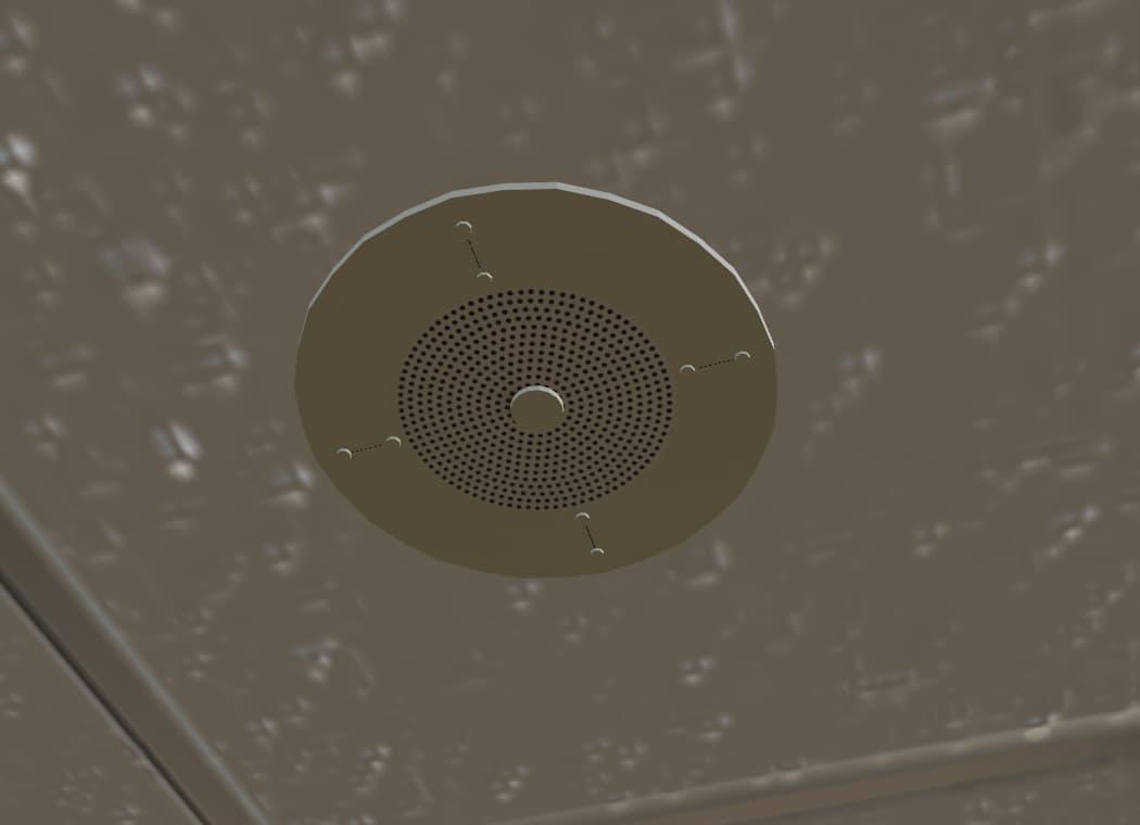 A beige, round speaker on the ceiling